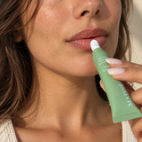 Woman applying MATINÉ Vanilla Lip Balm with Palestinian olive oil