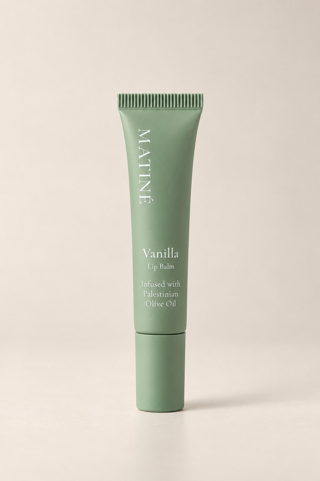 MATINÉ Vanilla Lip Balm in a matte sage green tube, infused with Palestinian olive oil.